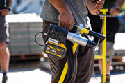 Paver vacuum attached to hardscape T-handle with a blurred background