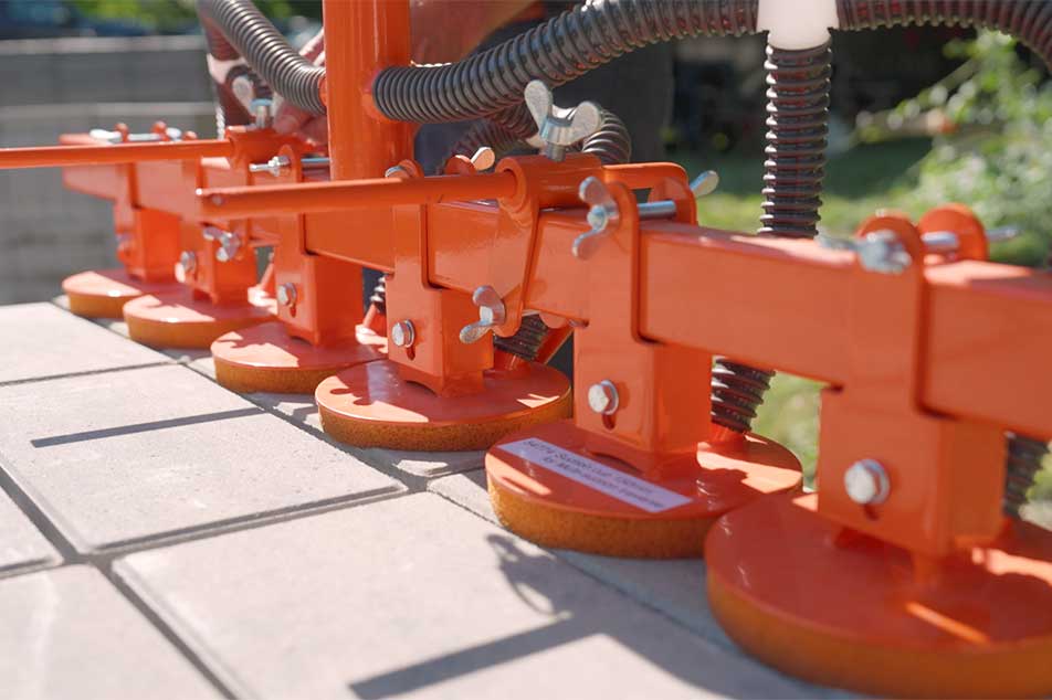 Close-up of orange mechanical components on a tiled floor